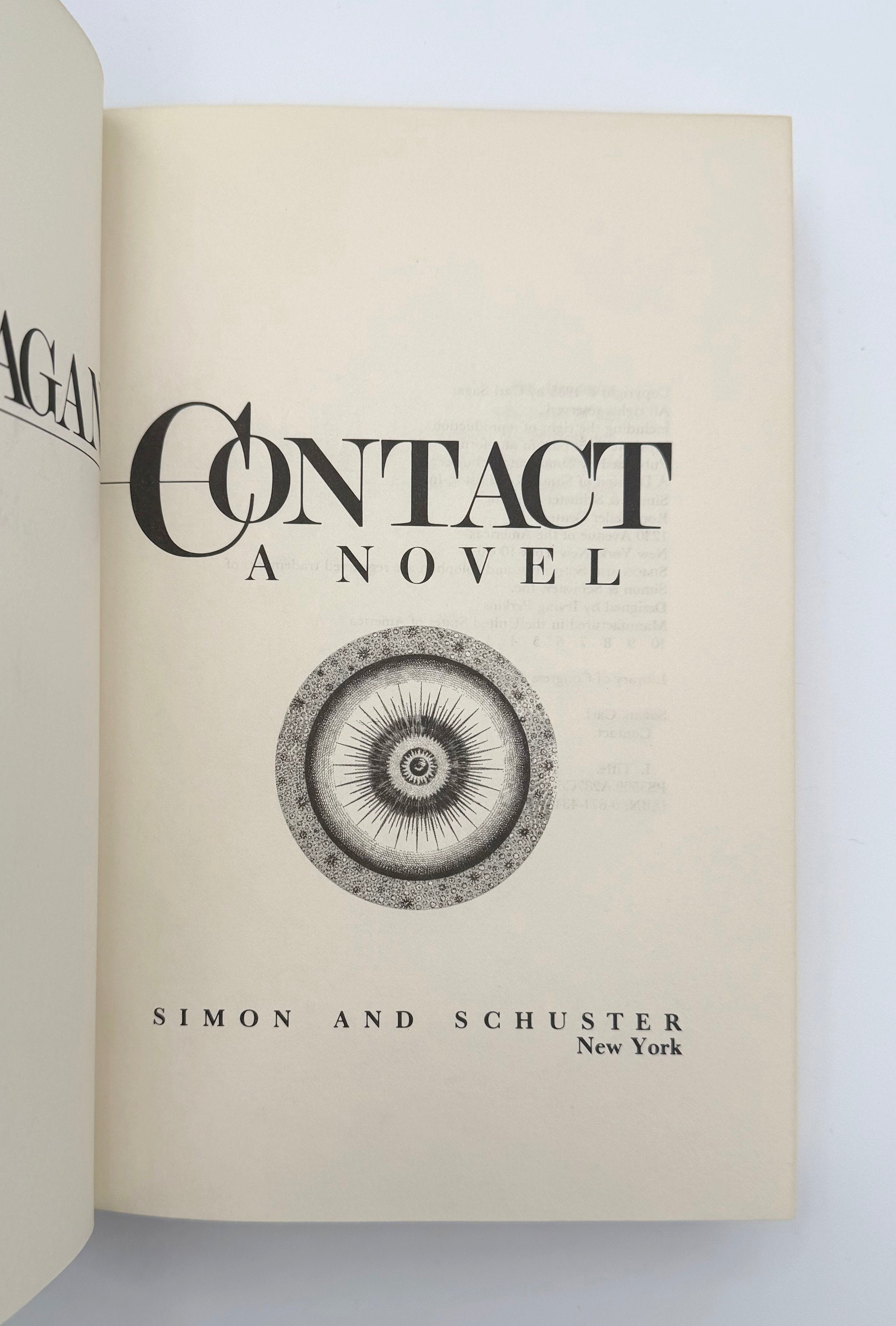 Open book showing the title 'Contact: A Novel' by Simon & Schuster on a light background