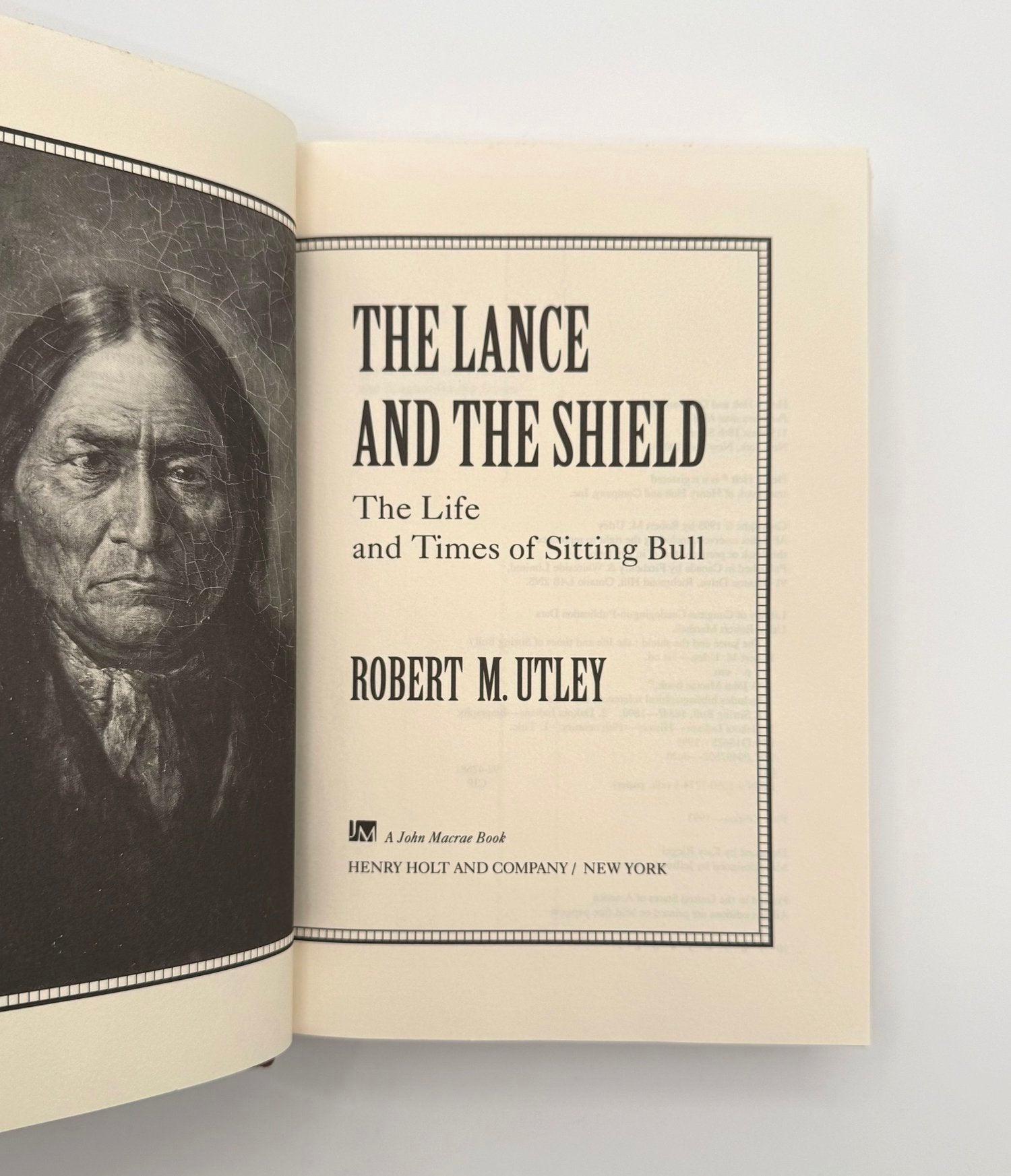 Book titled 'The Lance and The Shield' by Robert M. Utley with a portrait on the left page.