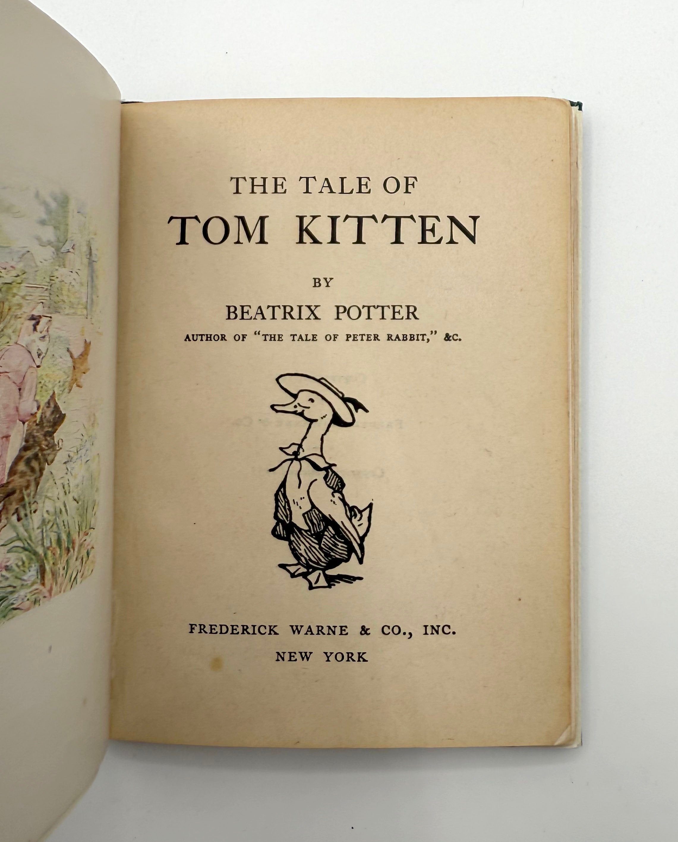 Title page of 'The Tale of Tom Kitten' by Beatrix Potter with illustration on a white background