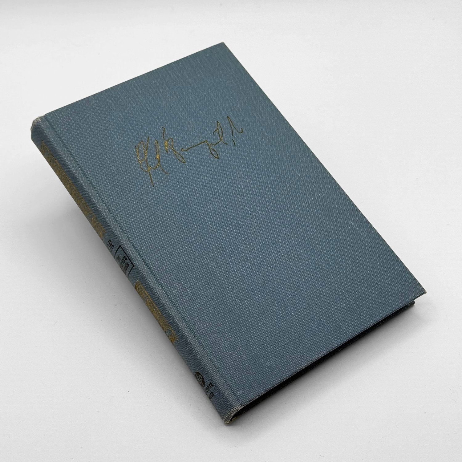Blue book with gold text on a white background