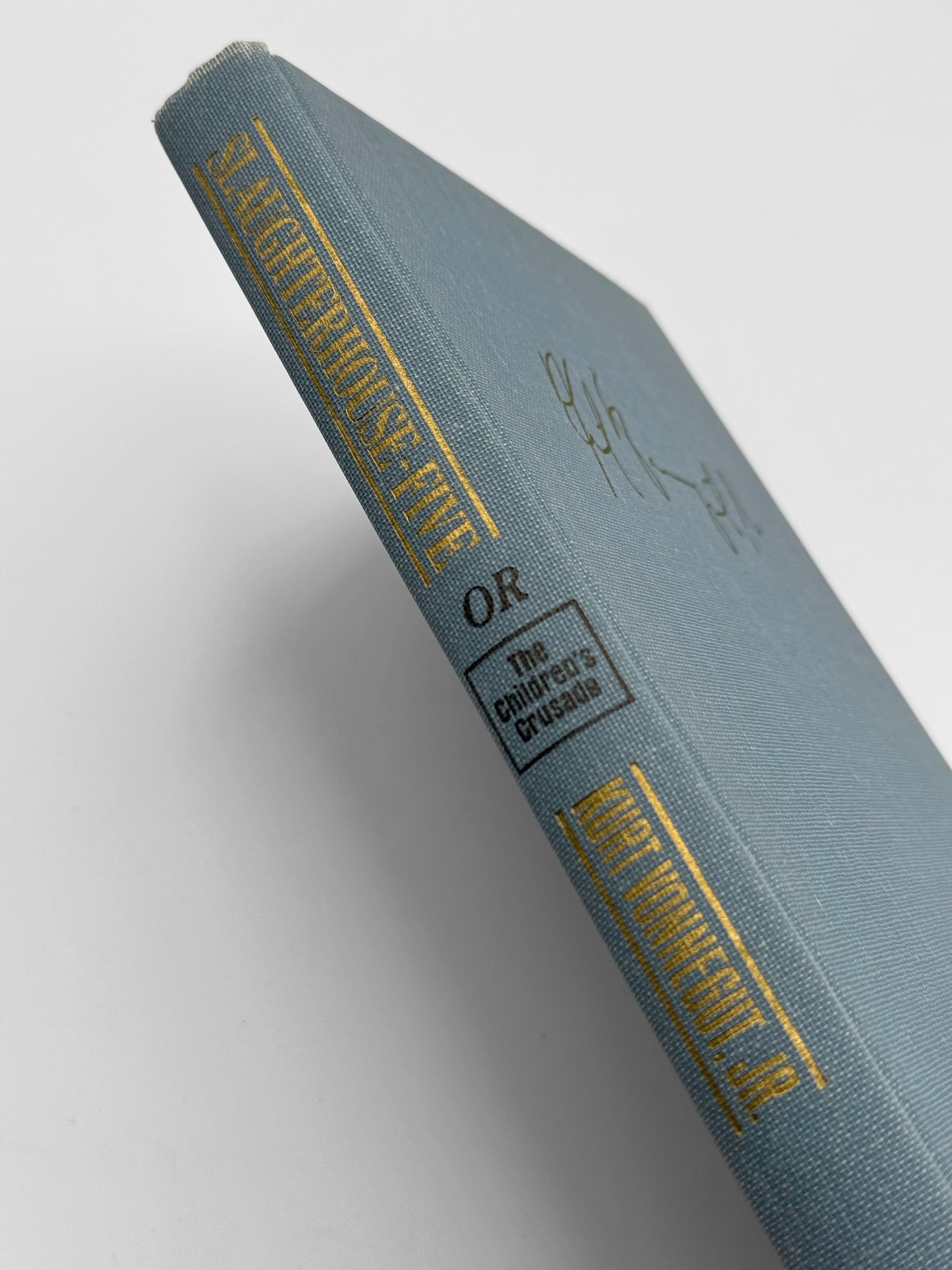 Blue book with gold text on a white background