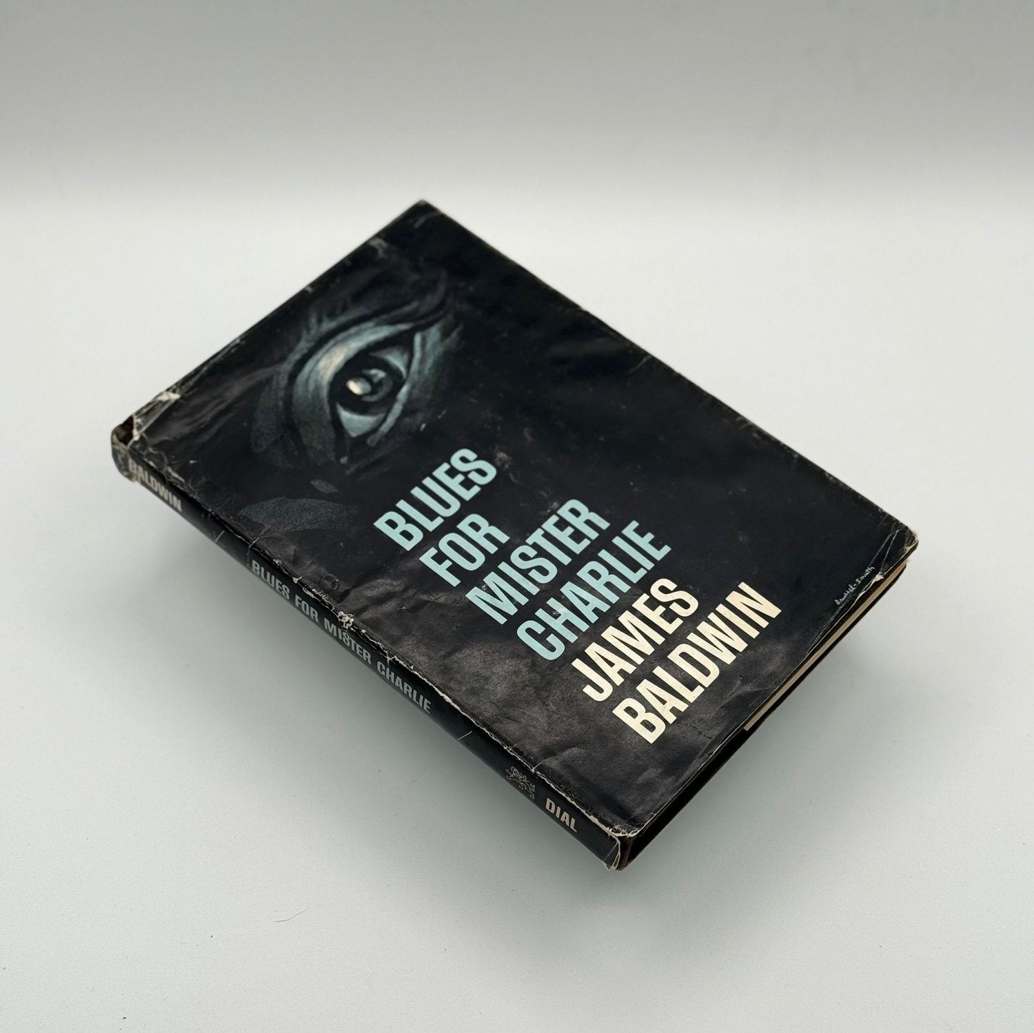 Book titled 'Blues for Mister Charlie' by James Baldwin on a gray background
