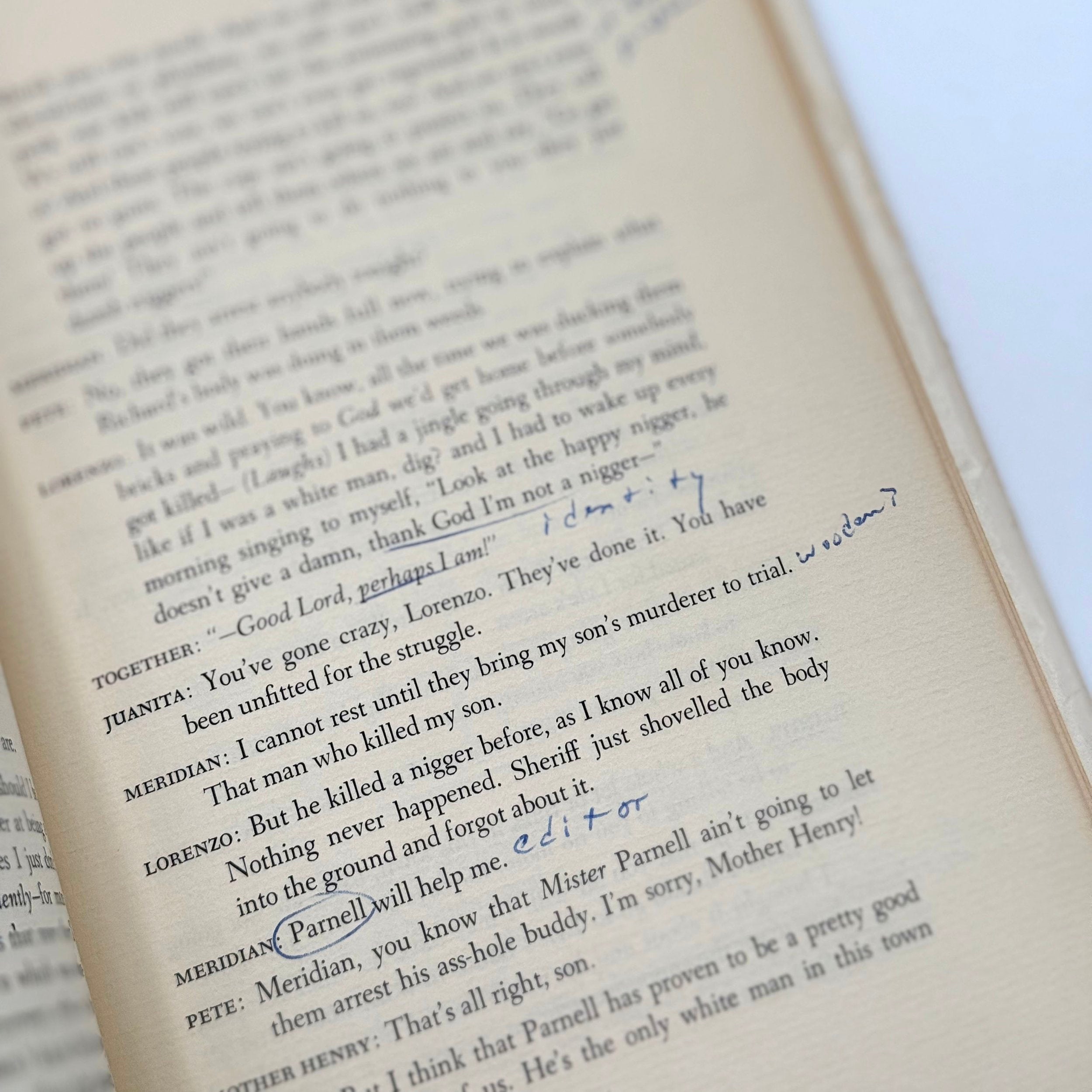 Open book with handwritten notes and corrections on a white background