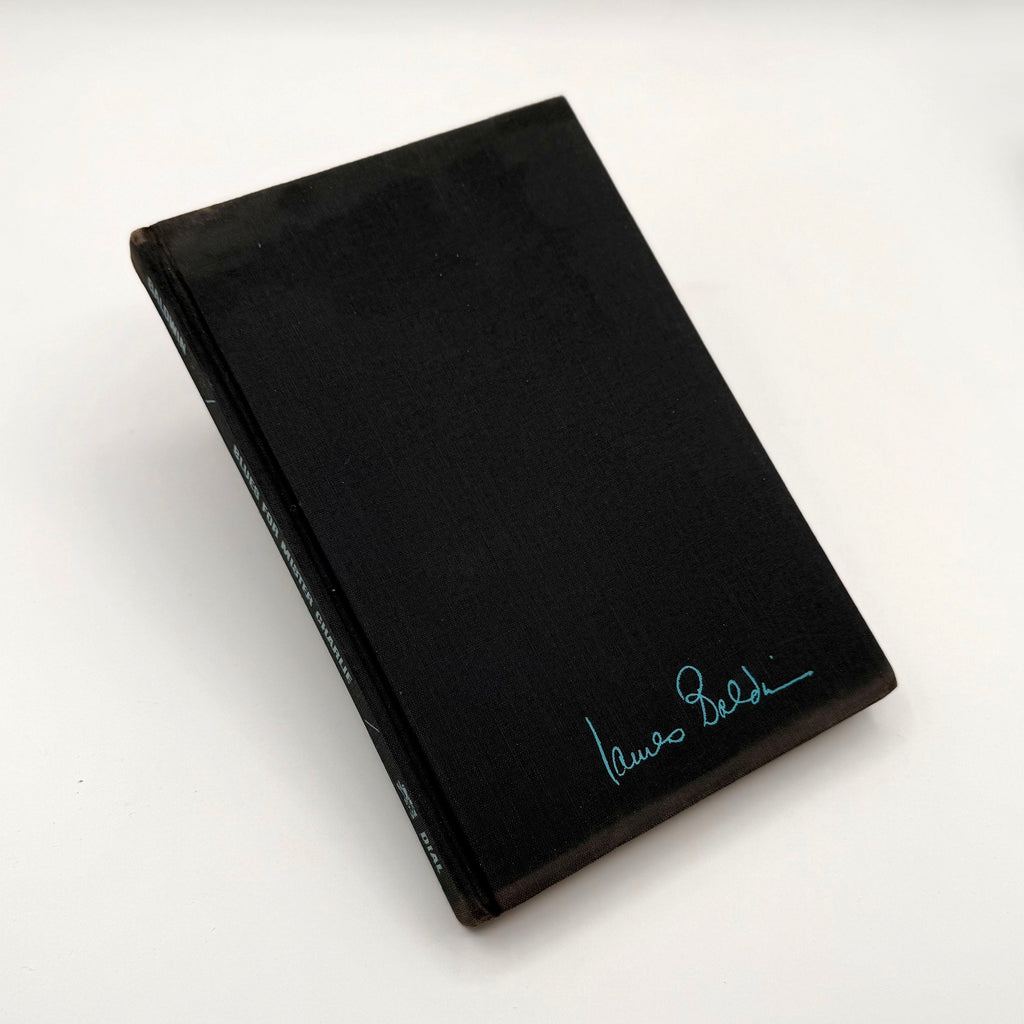 Black book with a signature on a white background