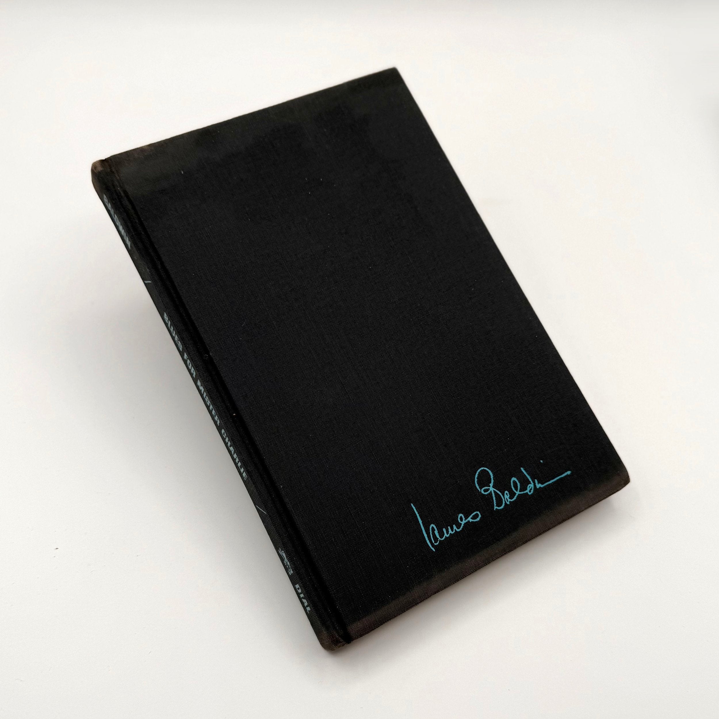Black book with a signature on a white background