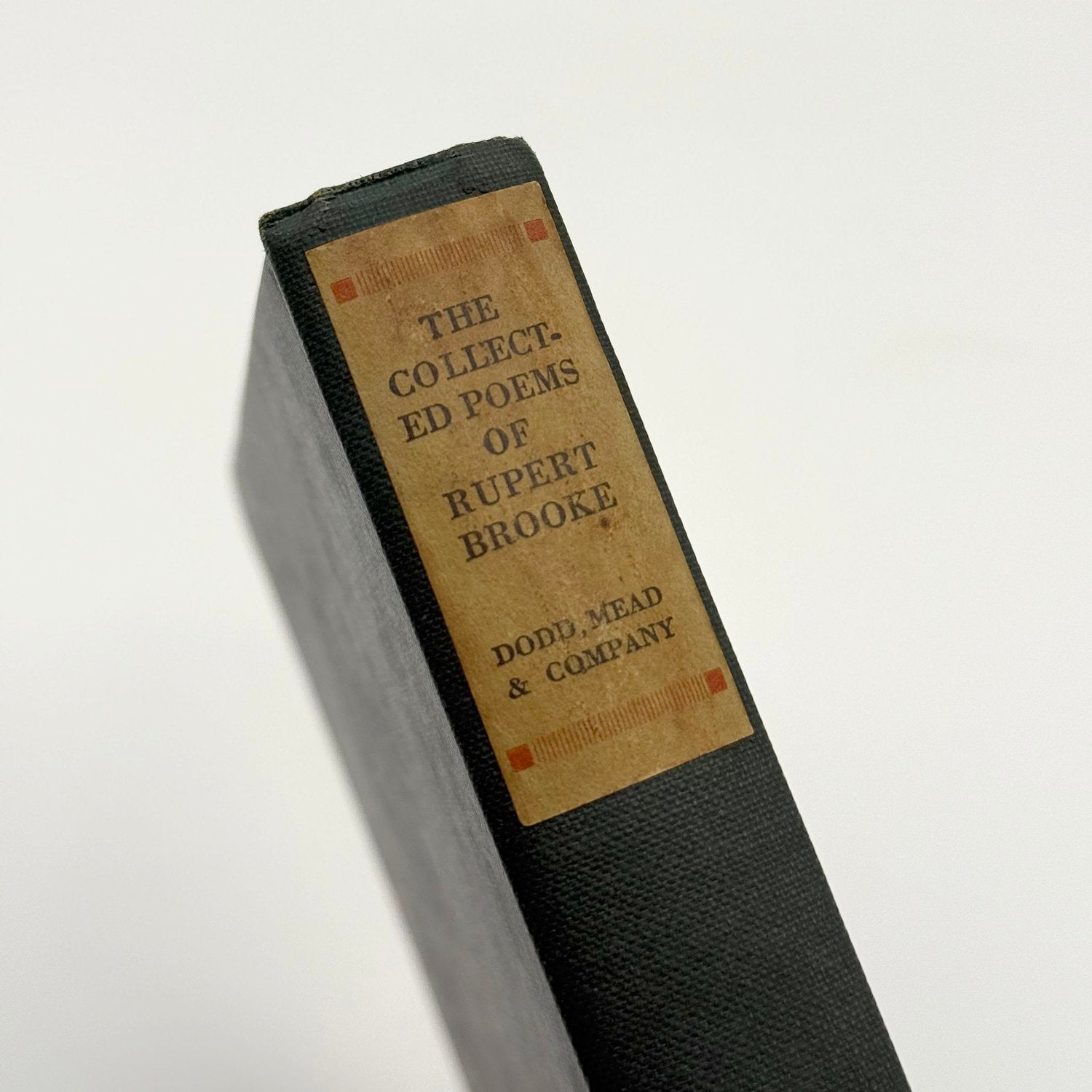 Book spine with 'The Collected Poems of Rupert Brooke' on a white background