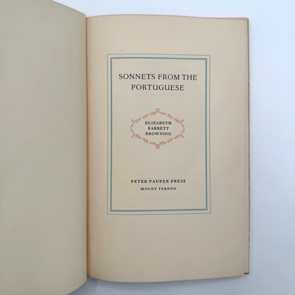 Open book with 'Sonnets from the Portuguese' by Elizabeth Barrett Browning on a light blue background