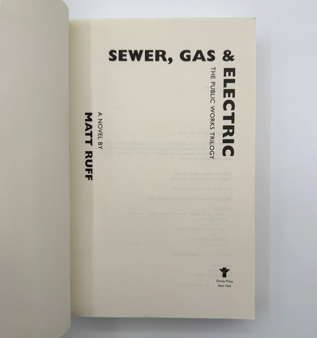 Book titled 'Sewer, Gas & Electric' by Matt Ruff on a light gray background