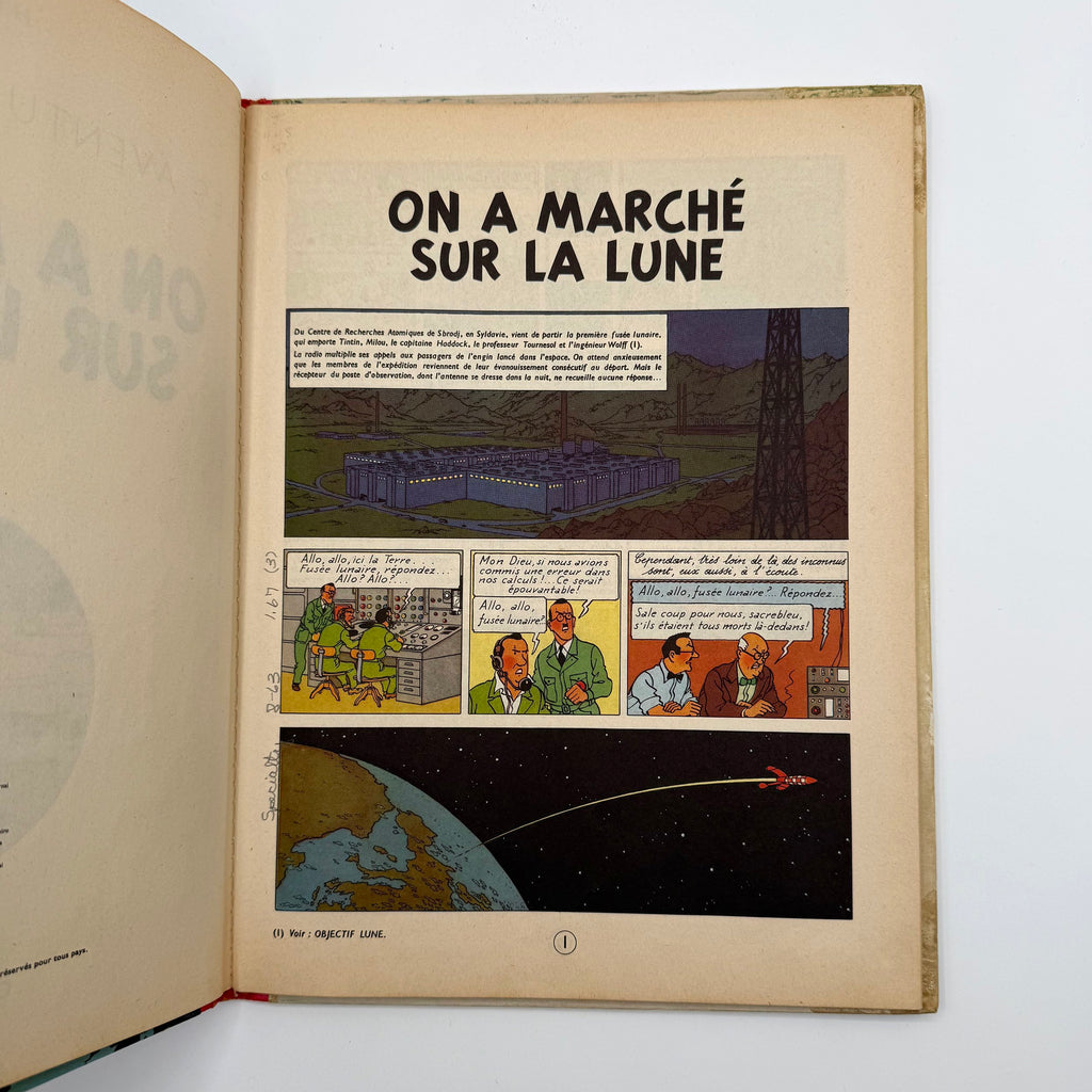Comic book open to a page titled 'On a Marché sur la Lune' with illustrations and text.