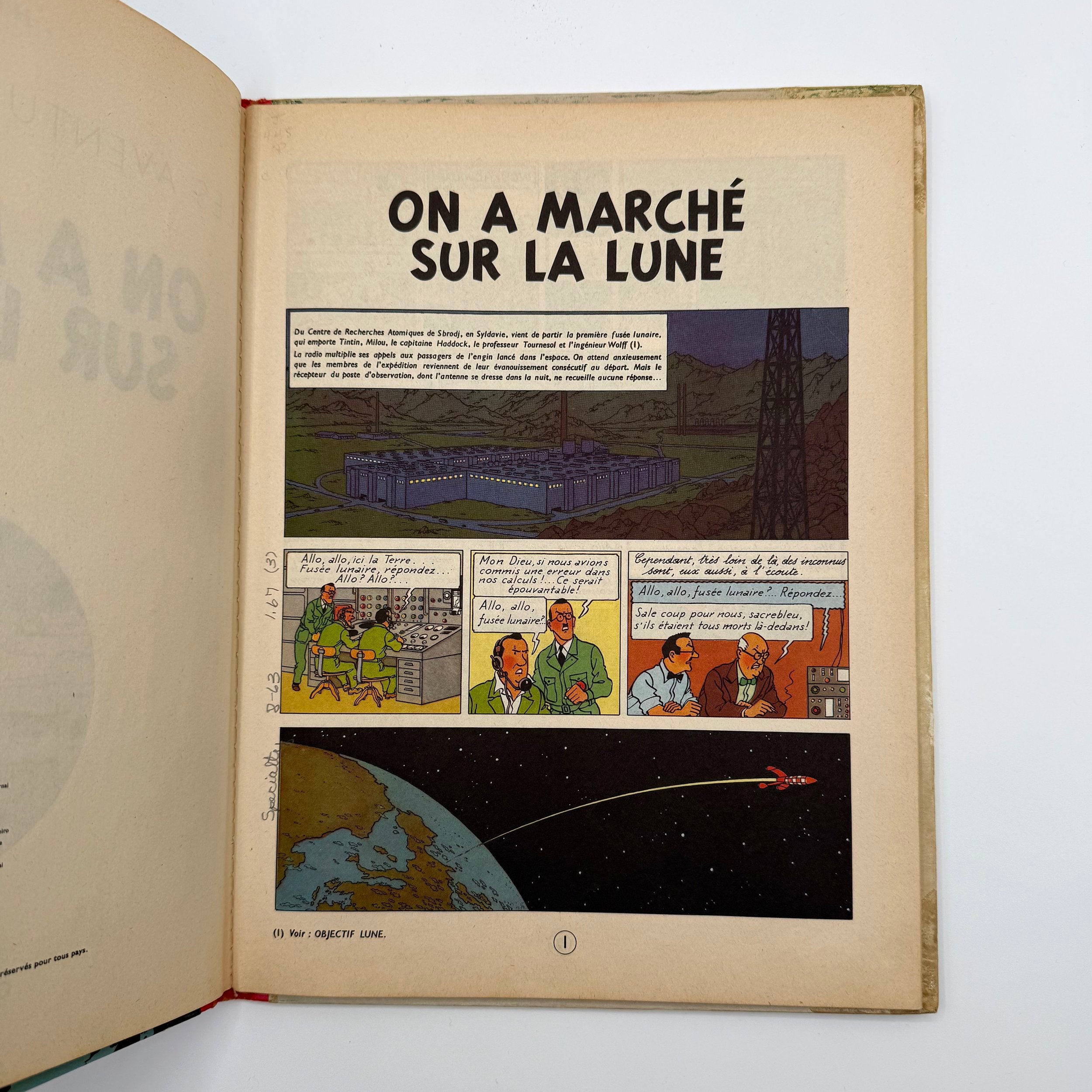 Comic book open to a page titled 'On a Marché sur la Lune' with illustrations and text.