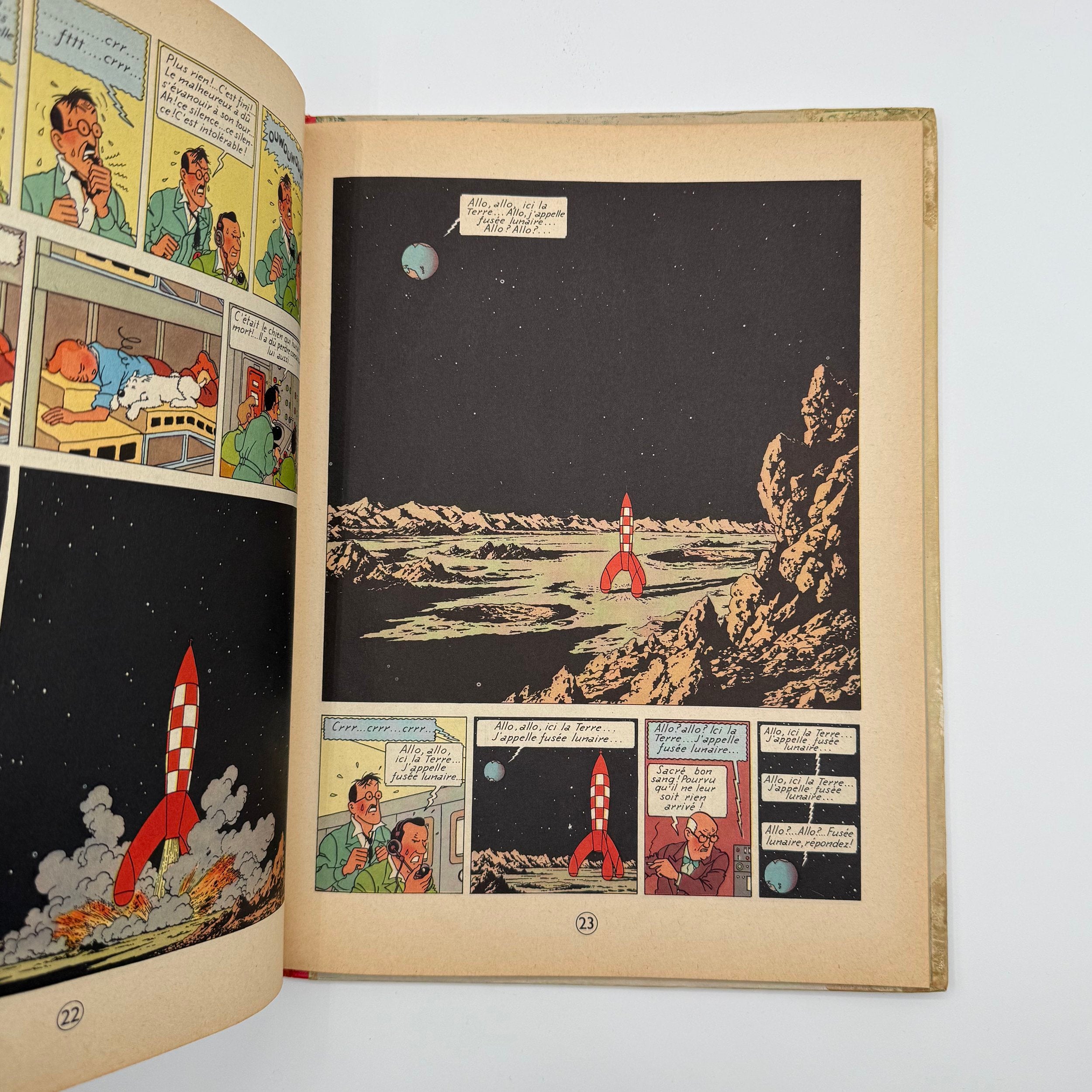 Open comic book with space-themed illustrations on a white background