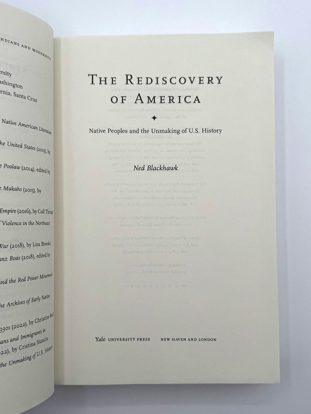 Open book with title 'The Rediscovery of America' by Ned Blackhawk on a white background