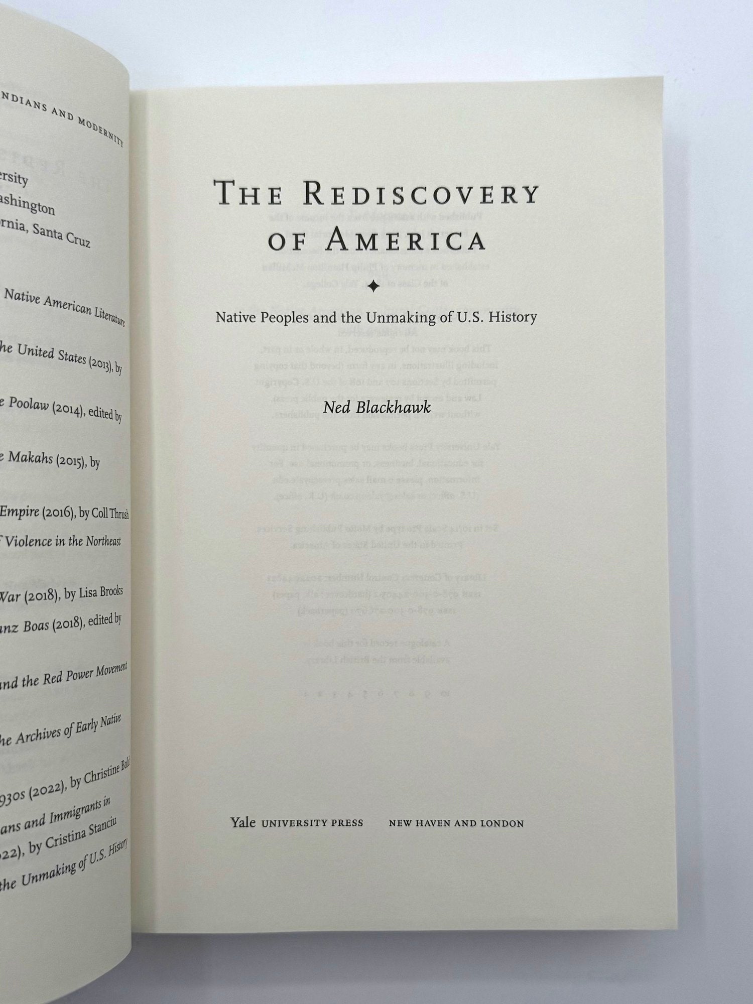 Open book with title 'The Rediscovery of America' by Ned Blackhawk on a white background