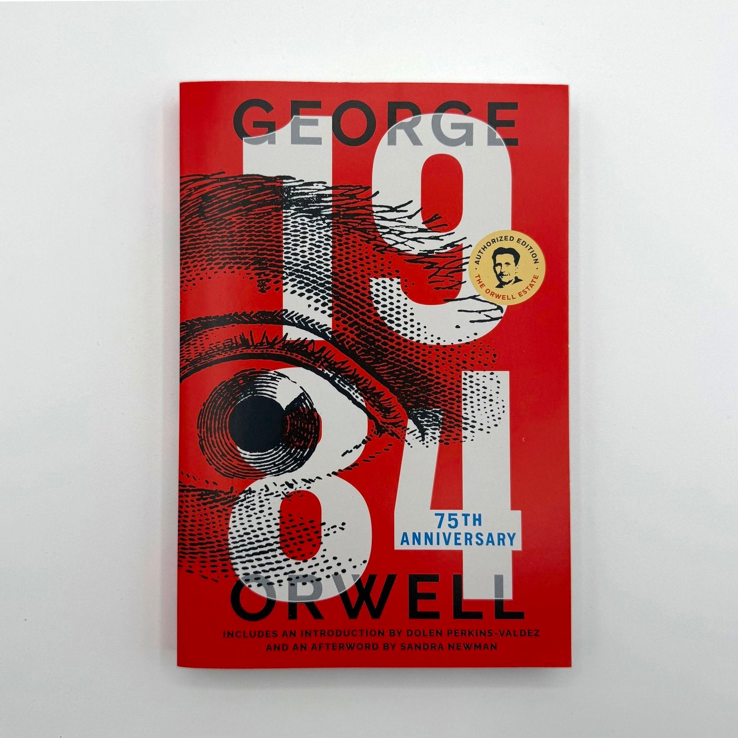 Book cover of '1984' by George Orwell with a red background and eye illustration.