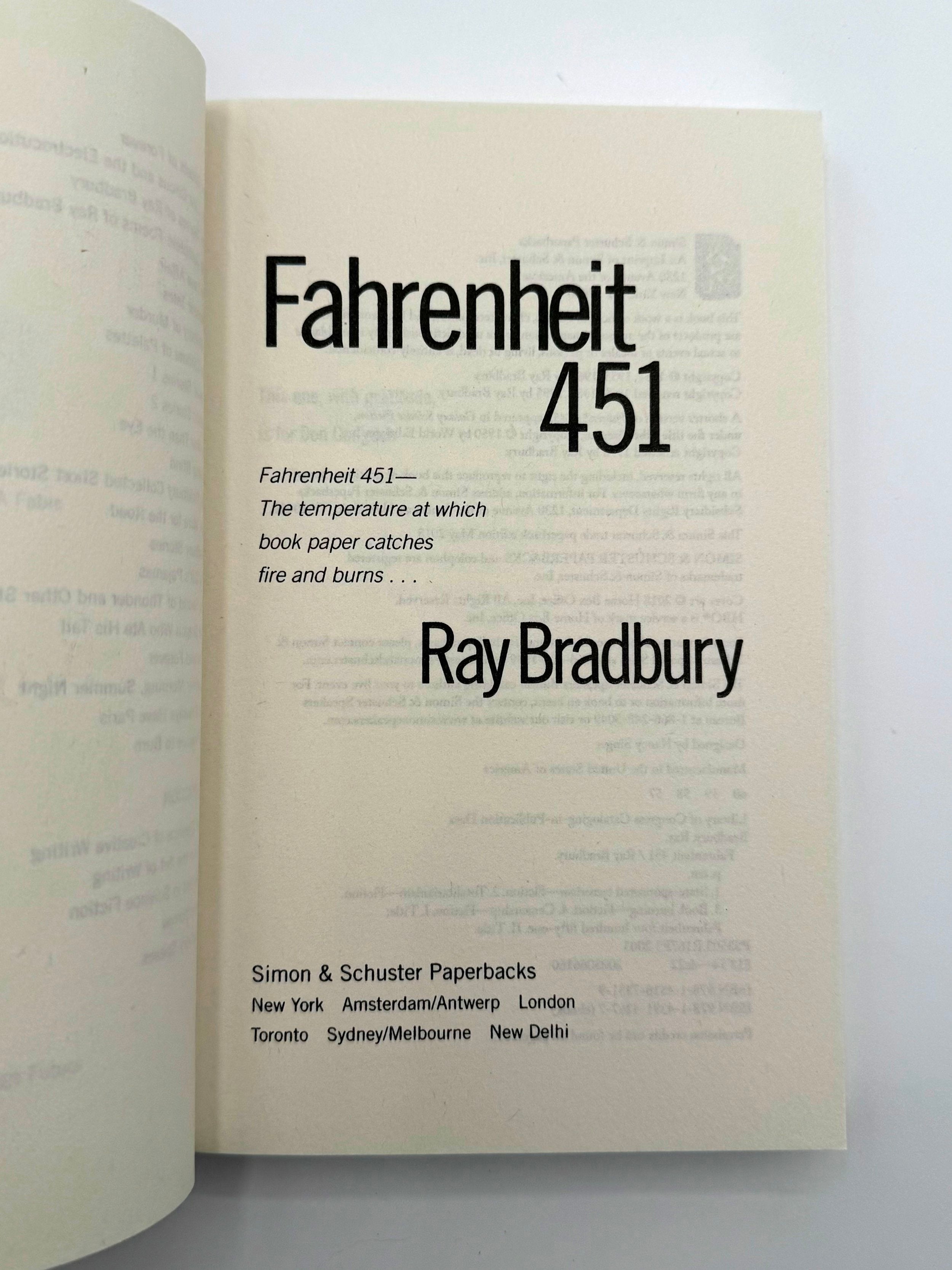 Open book displaying the title 'Fahrenheit 451' by Ray Bradbury.