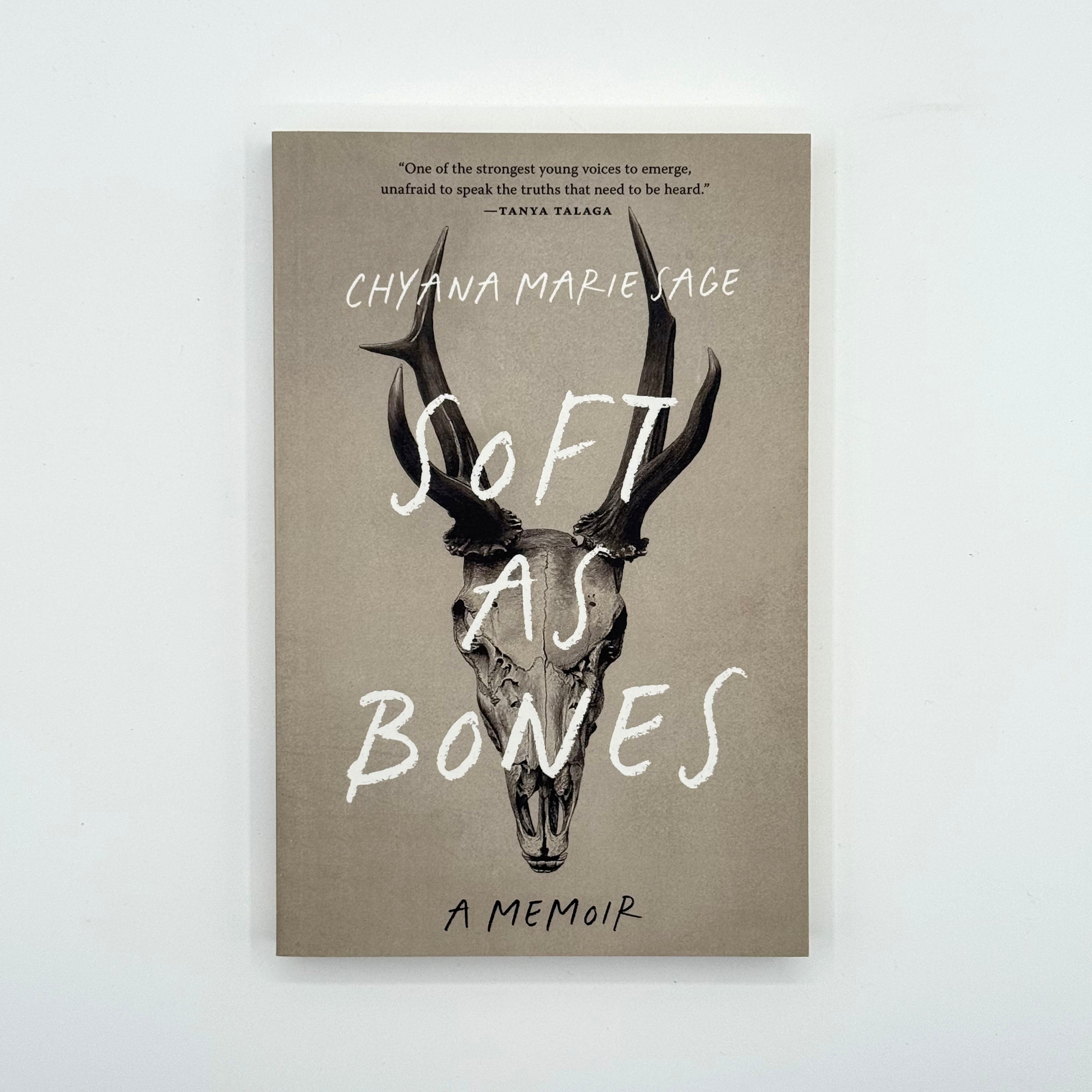 Book cover of 'Soft as Bones' with deer skull illustration and text on a beige background