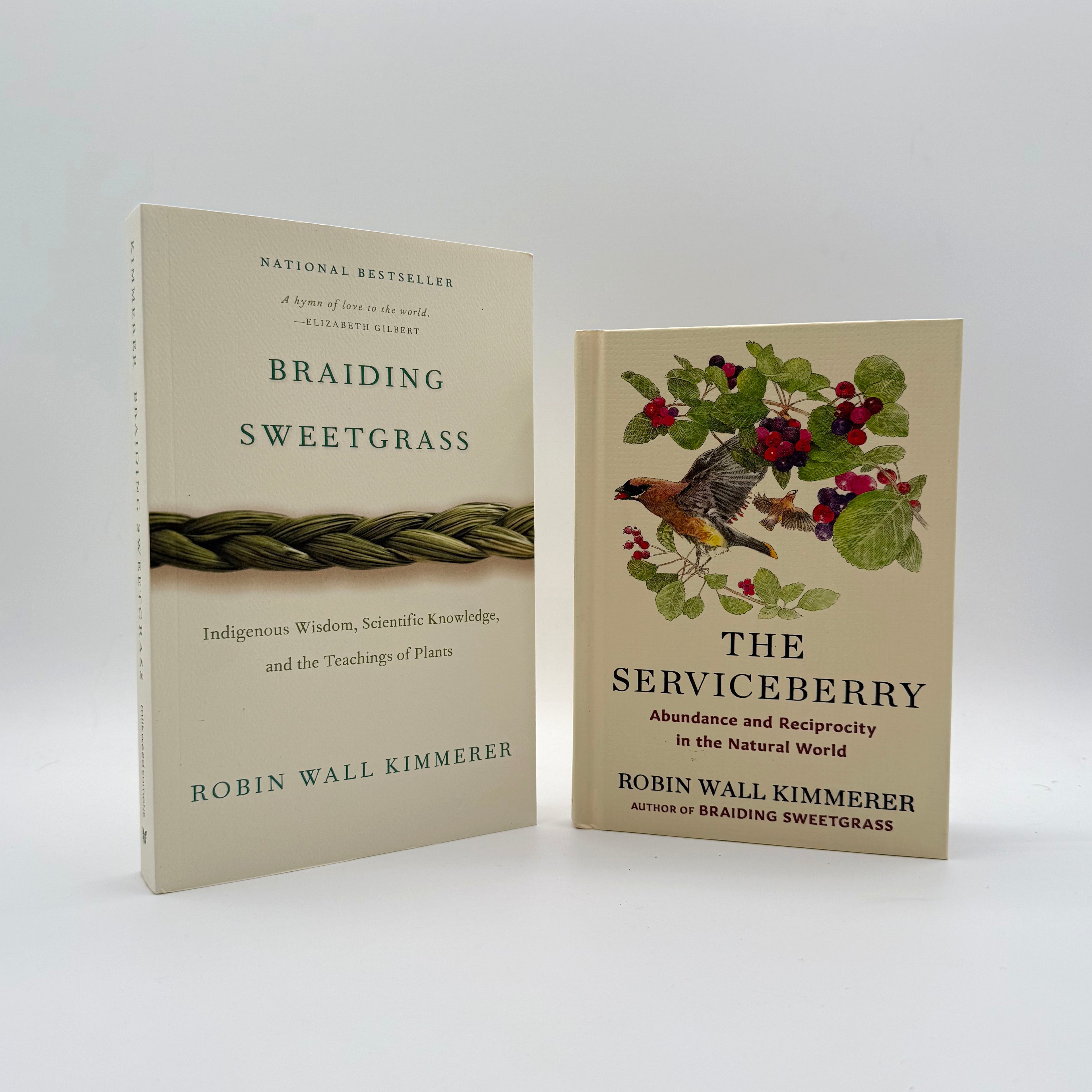 Two books by Robin Wall Kimmerer on a white background