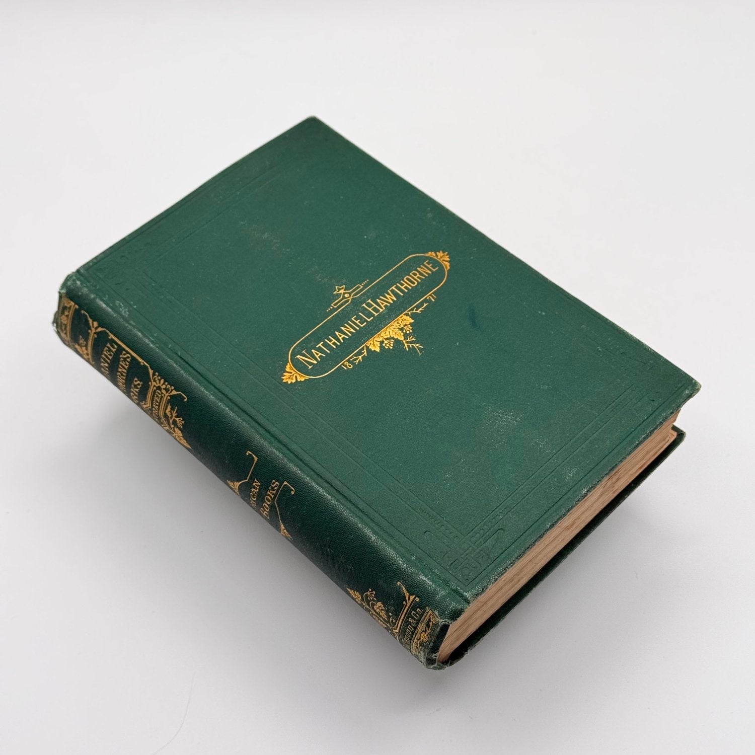 Vintage green book with gold embossed text on a white background