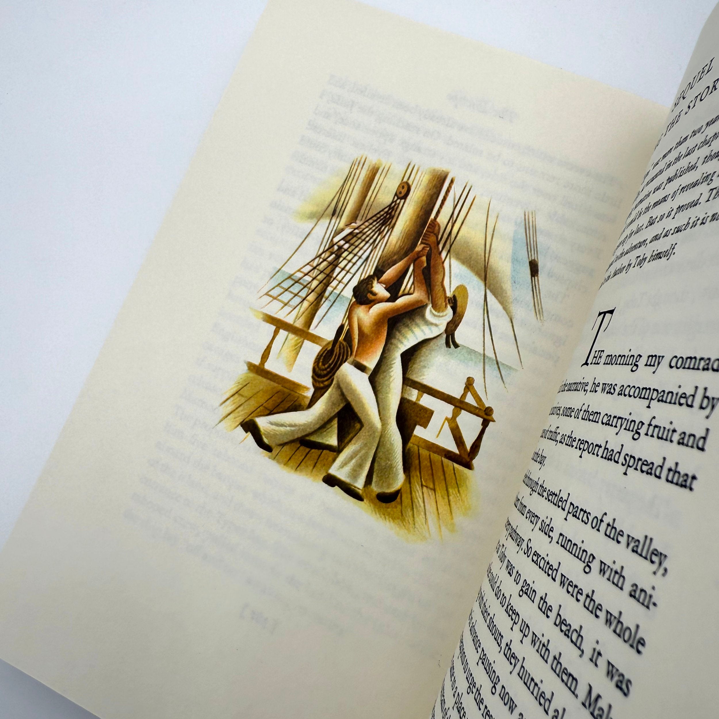 Open book with a decorative illustration of a couple sailors on a sailboat