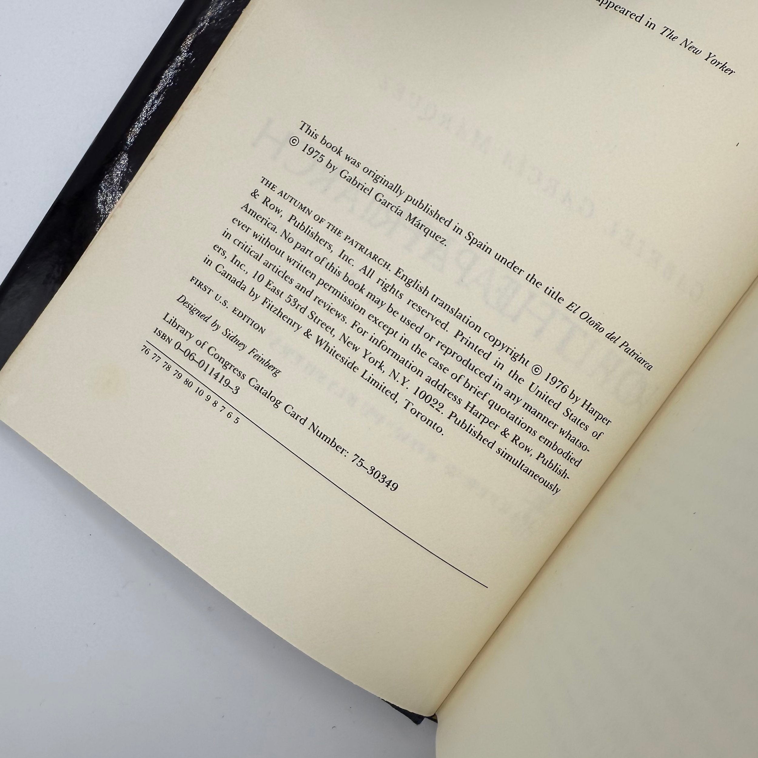 Open book with copyright and publishing information on a white background
