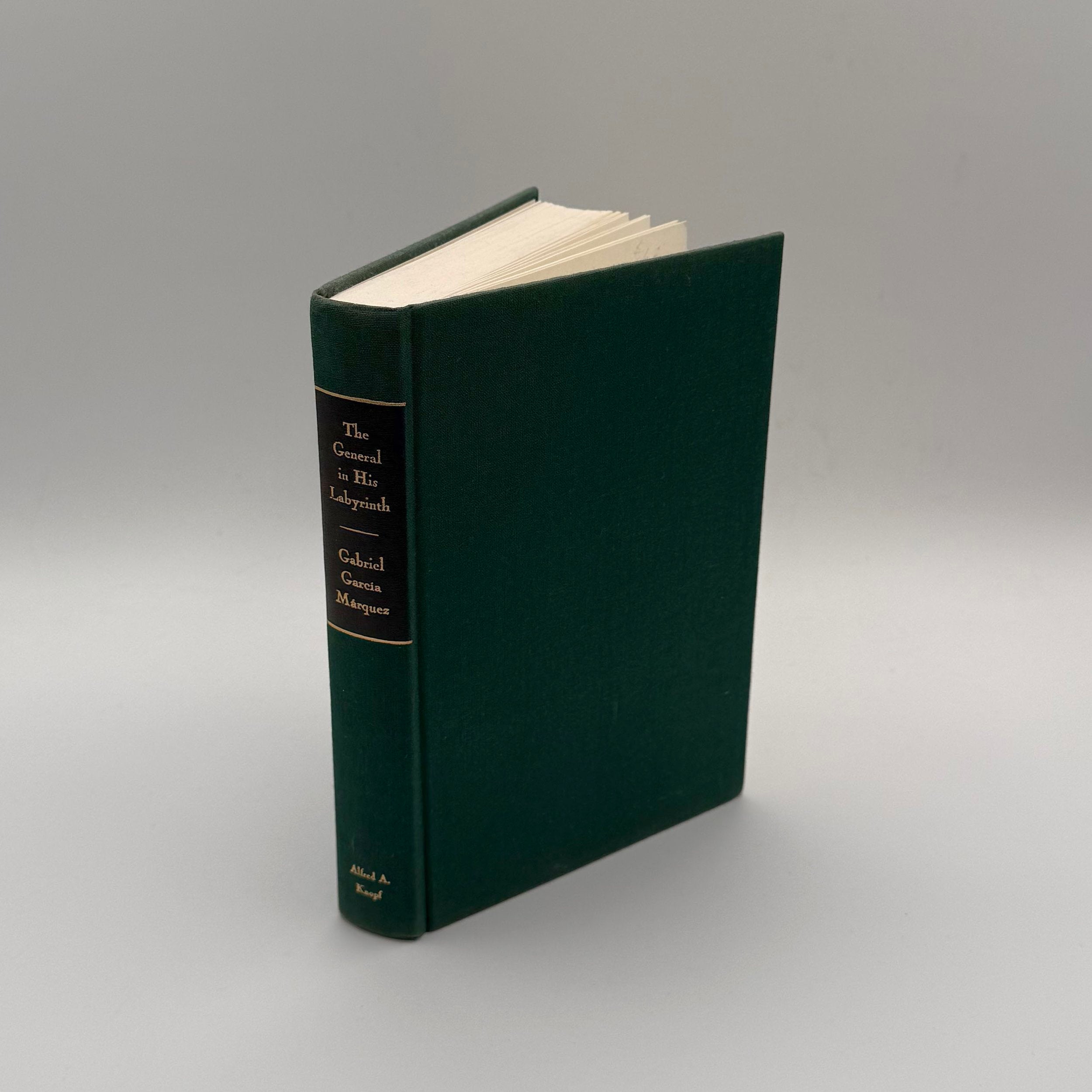 Green book with a black label on a gray background