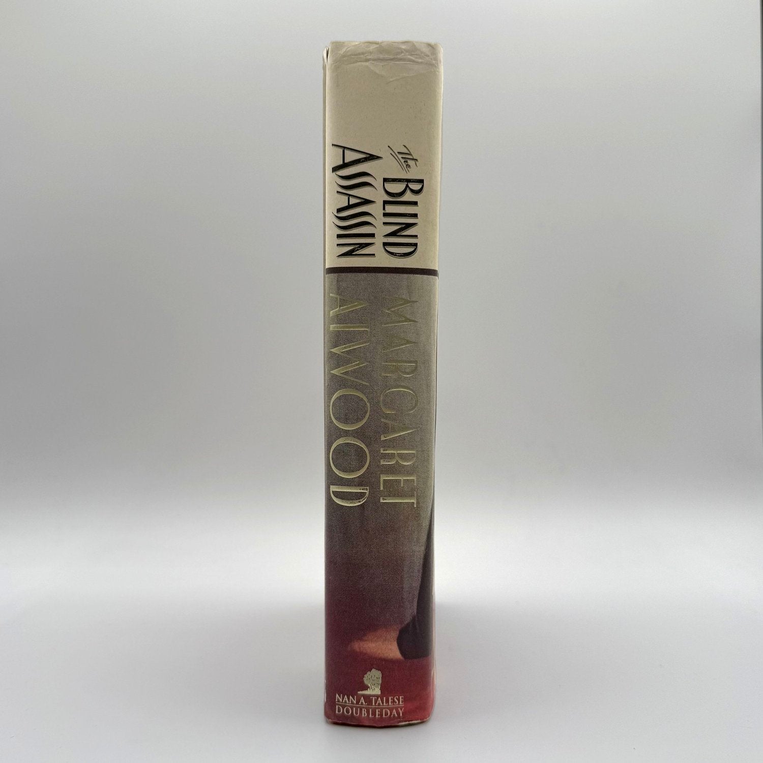 Book titled 'The Blind Assassin' by Margaret Atwood on a white background