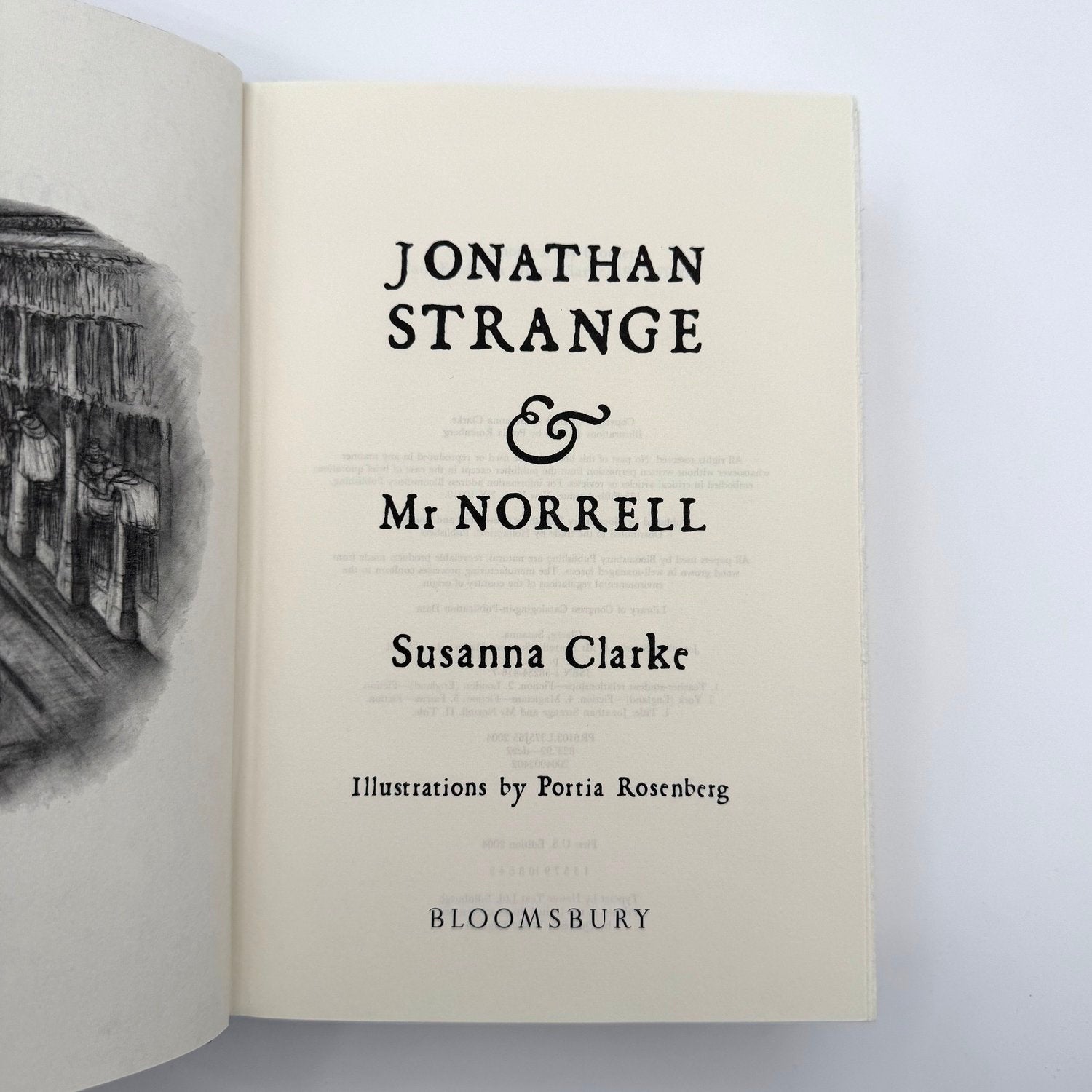 Book open to the title page of 'Jonathan Strange & Mr Norrell' by Susanna Clarke with illustrations by Portia Rosenberg.