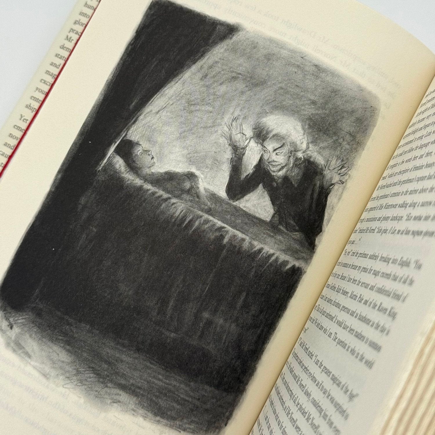Illustration of a man in a suit looking at a woman in a dark room on an open book.