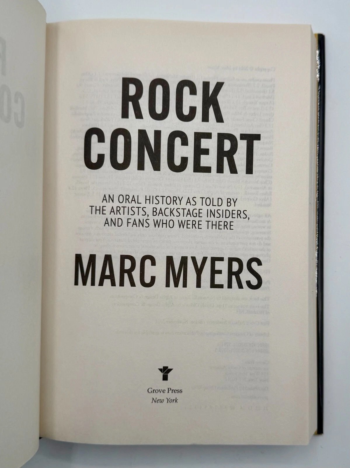 Open book with title 'Rock Concert' by Marc Myers on a white background