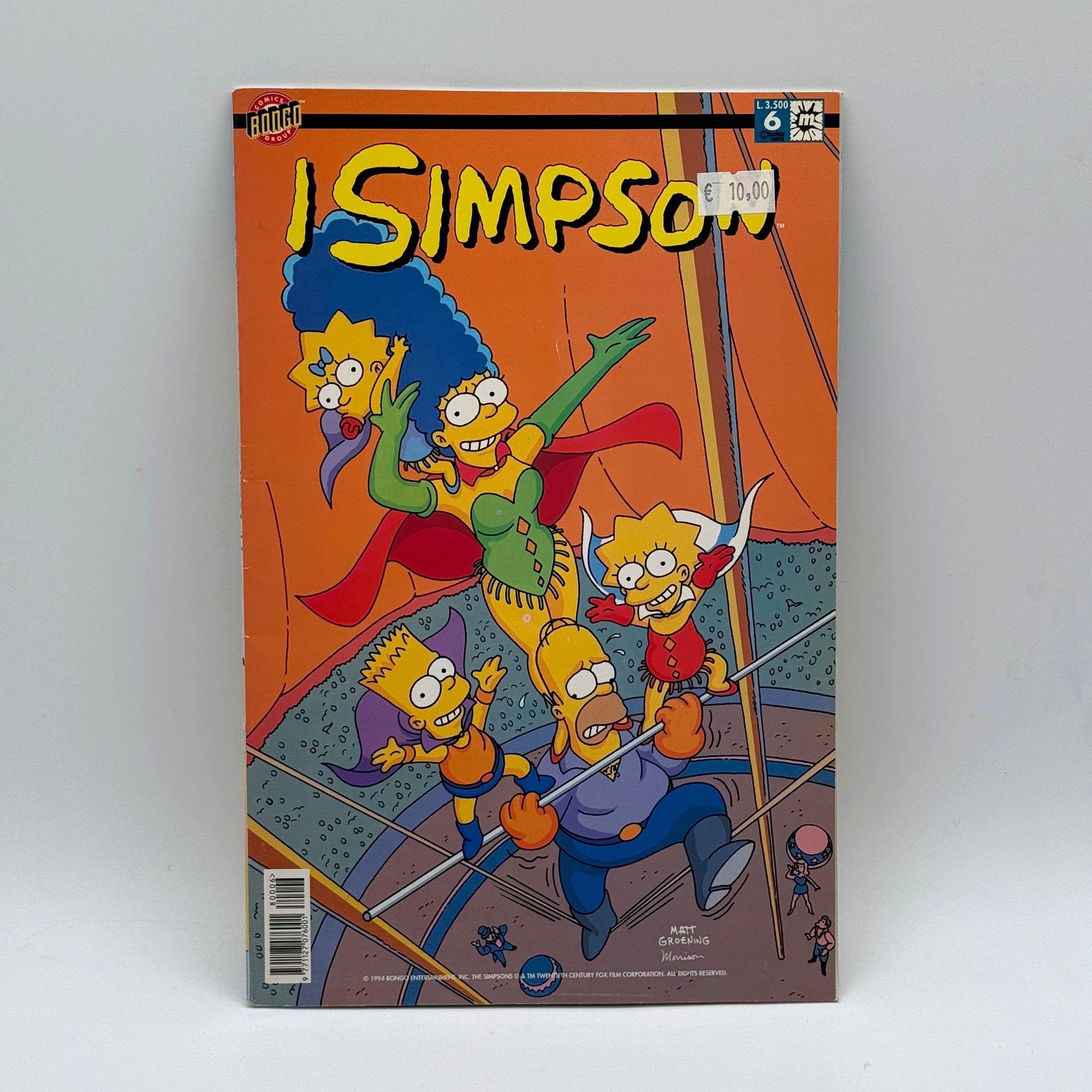 Comic book cover featuring characters from 'The Simpsons' on a gray background