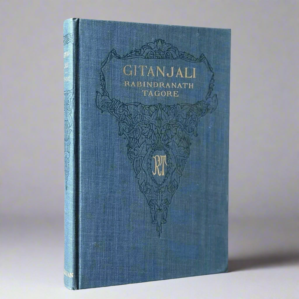 Blue book titled 'Gitanjali' by Rabindranath Tagore on a beige background
