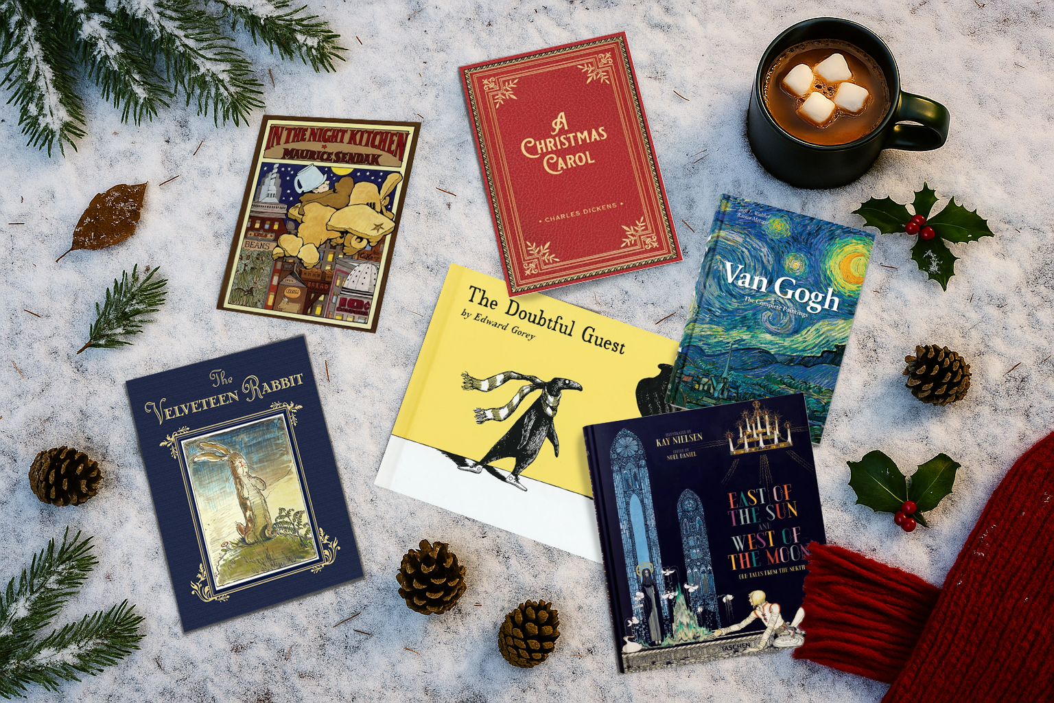 Collection of books on a snowy surface with a mug of hot chocolate and festive decorations.