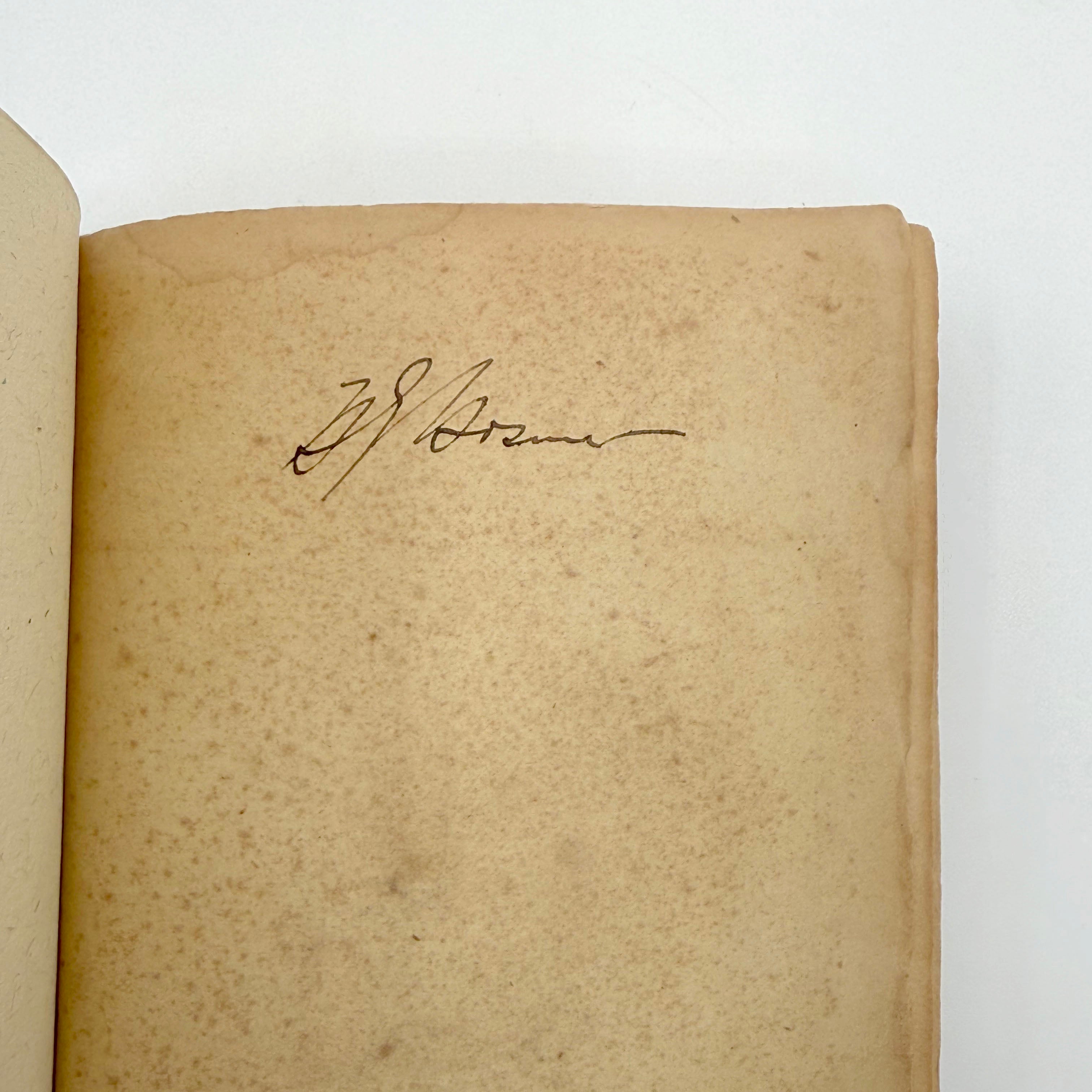 Vintage book with a signature on a white background