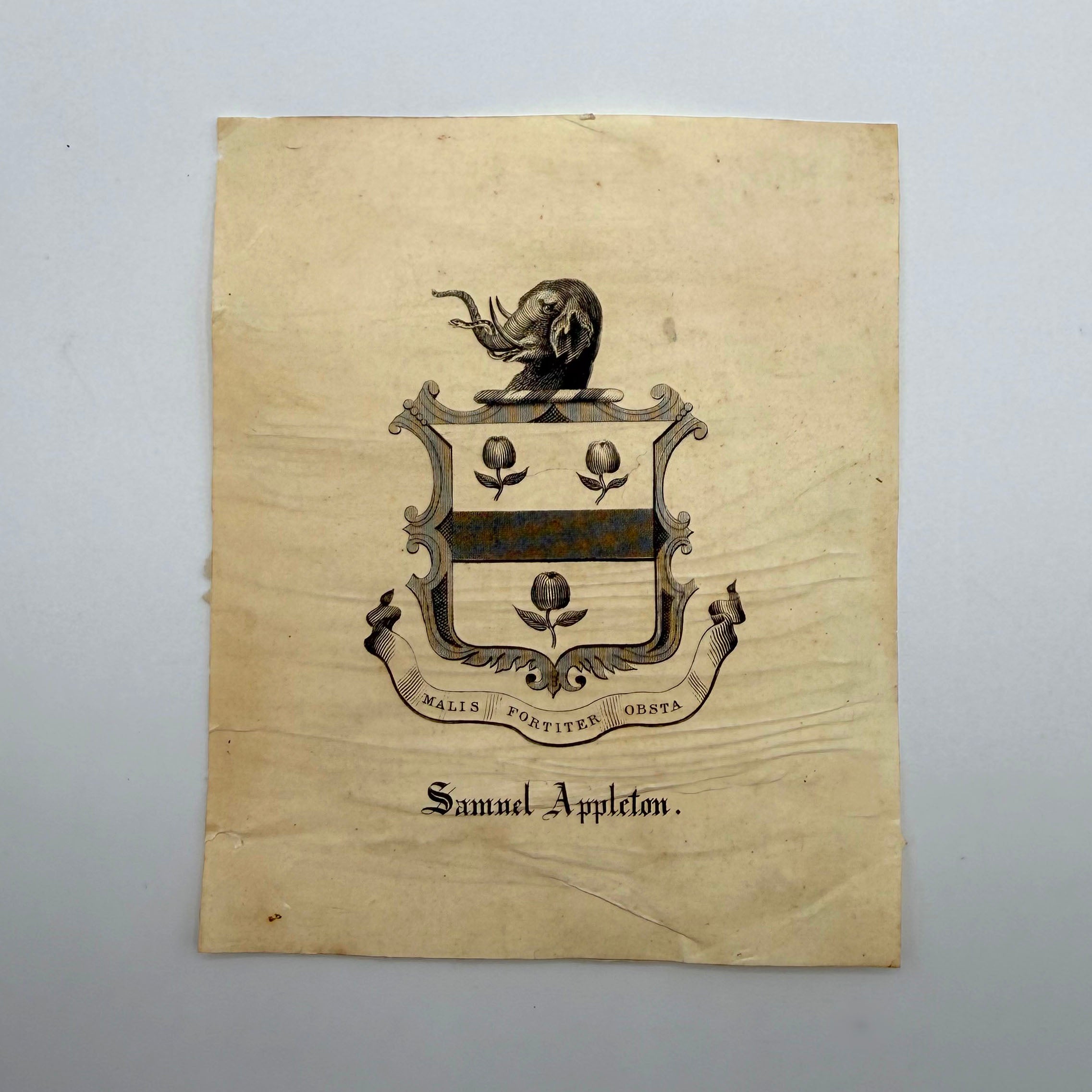 Vintage paper with a coat of arms and text on a gray background