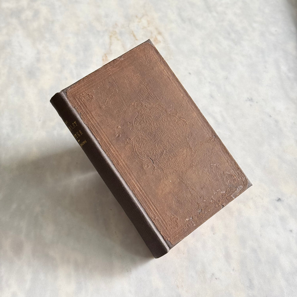 Brown book on a textured white surface