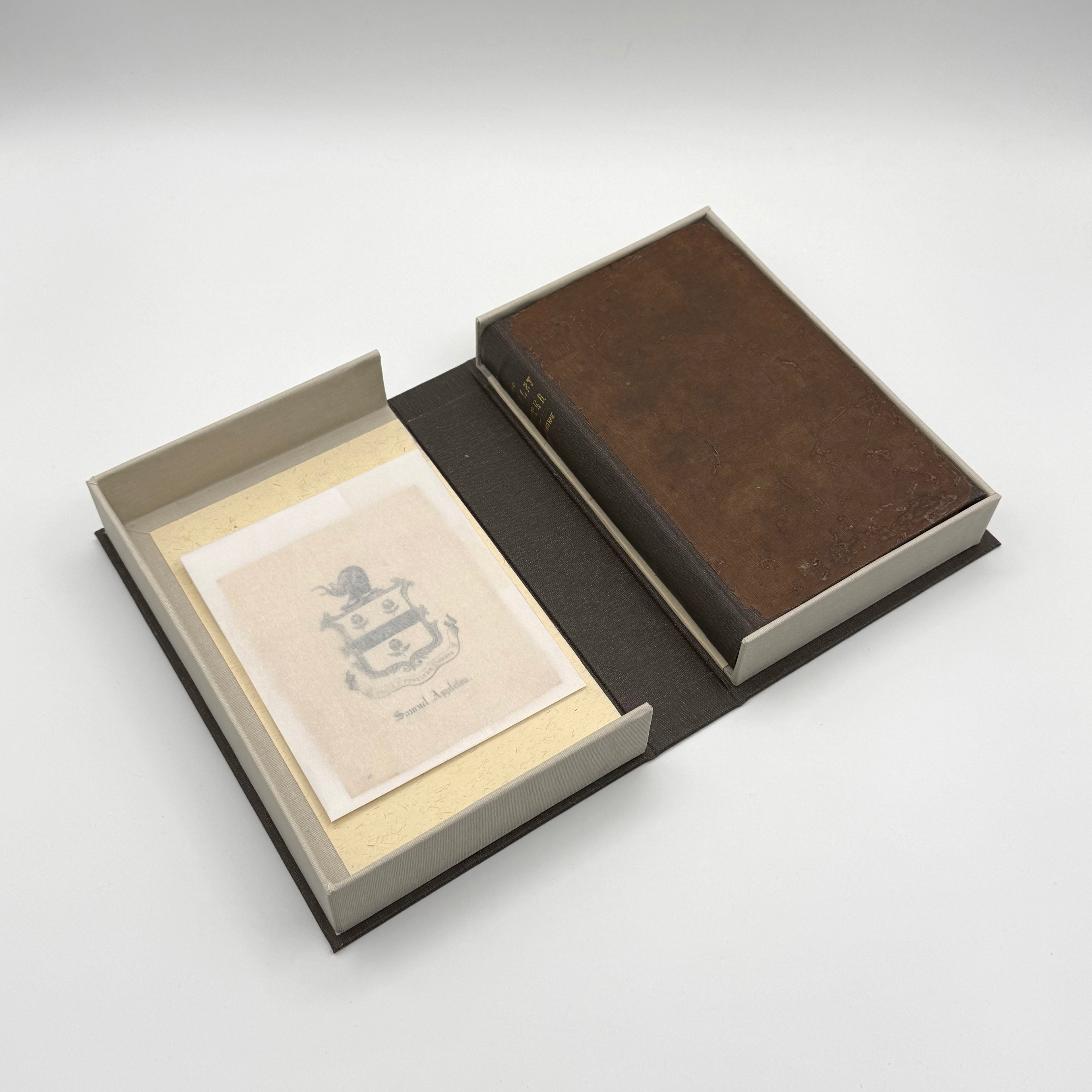 Brown book with a crest on a white background