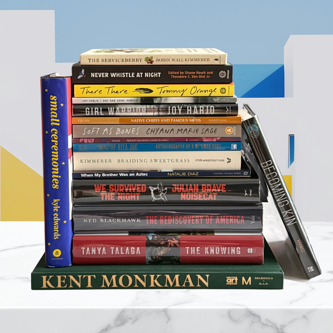 Stack of books on a white surface with a blue geometric background
