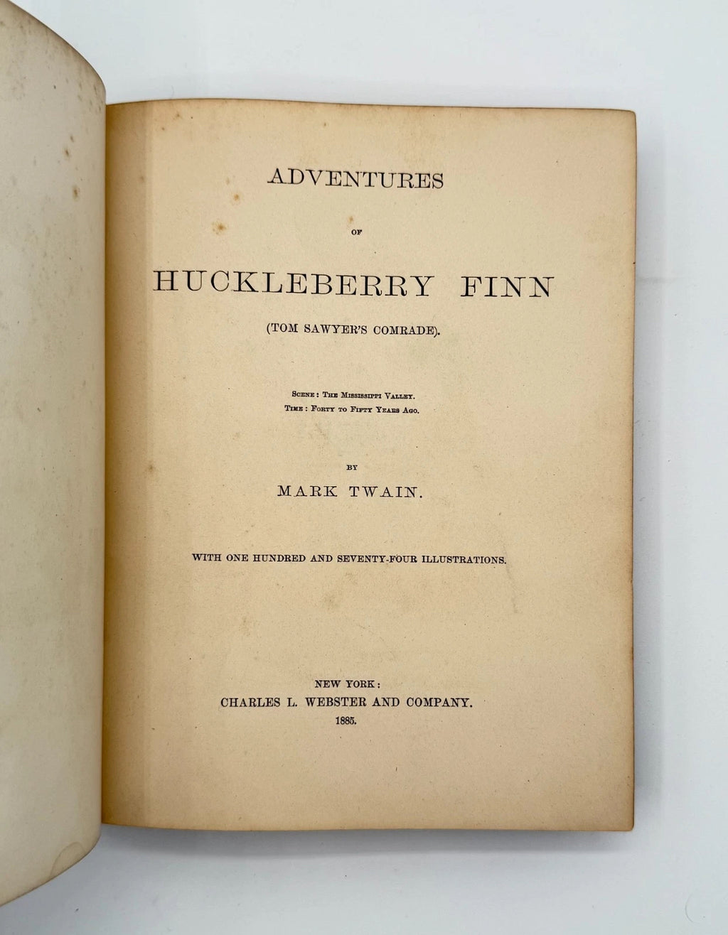 Title page of 'Adventures of Huckleberry Finn' by Mark Twain on a white background