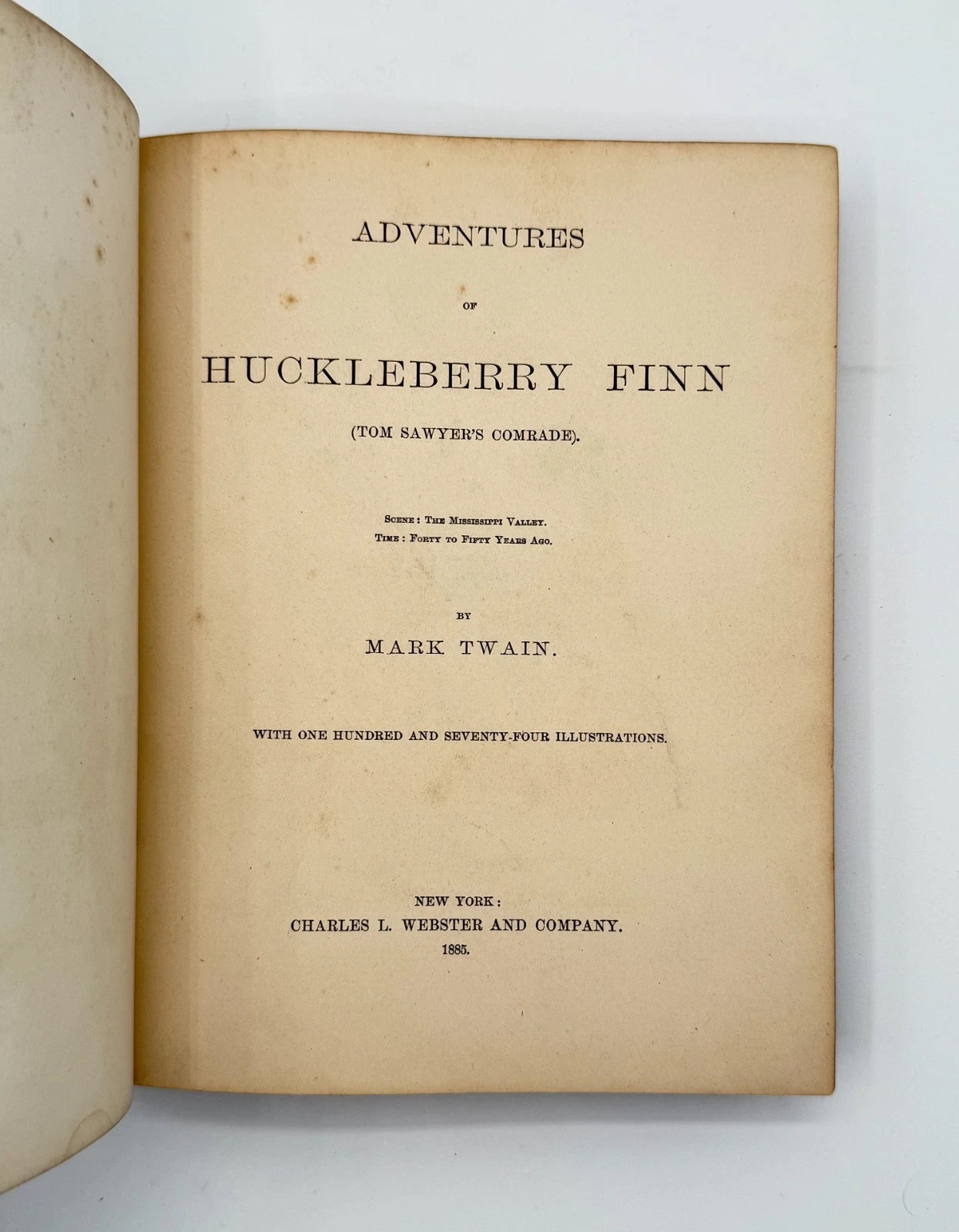 Title page of 'Adventures of Huckleberry Finn' by Mark Twain on a white background