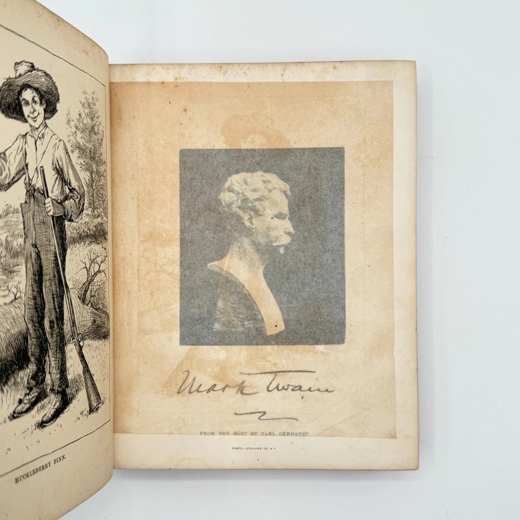 Open book with illustrations and a portrait of Mark Twain on a white background