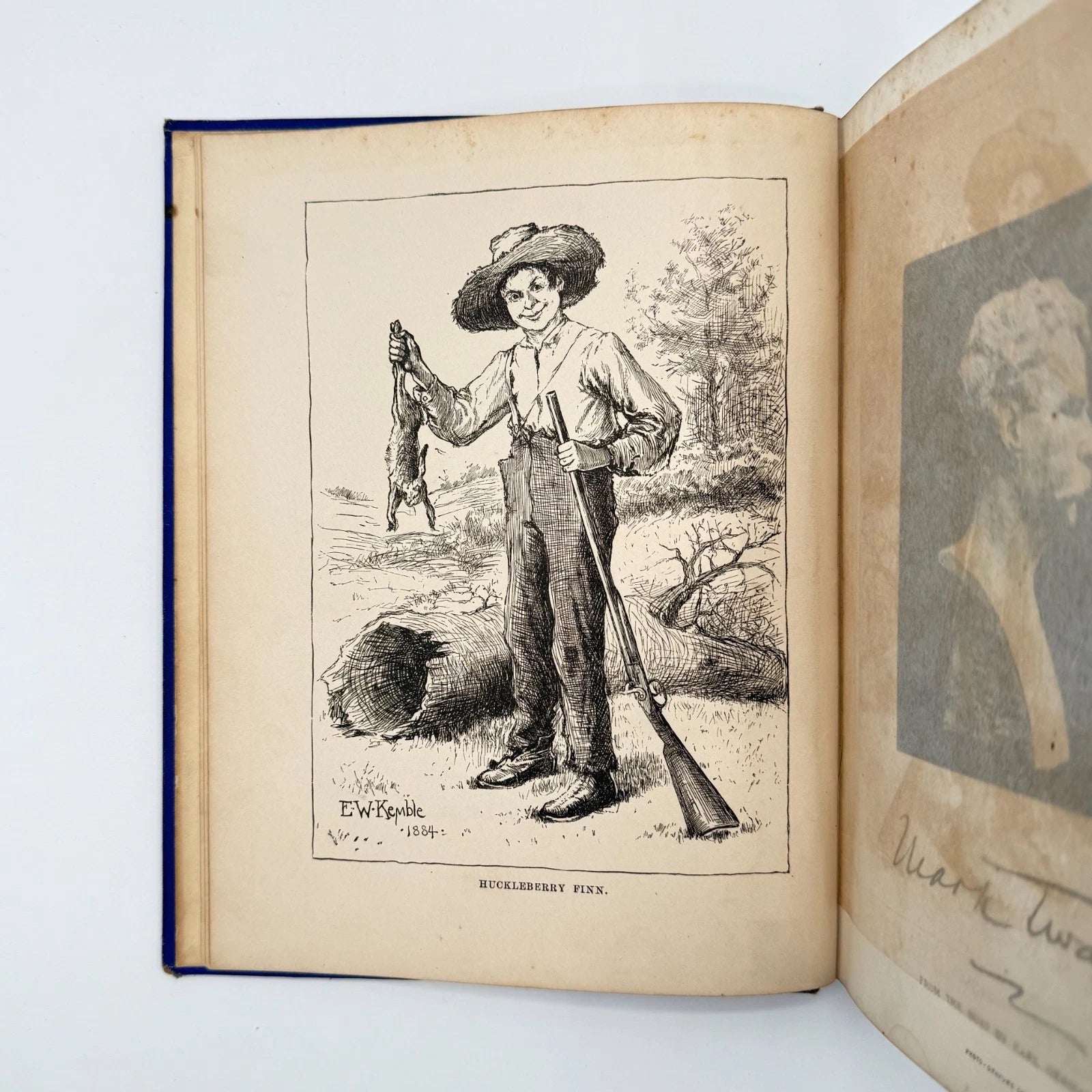 Open book with illustrations of a man holding a gun and a fish, on a light blue background.
