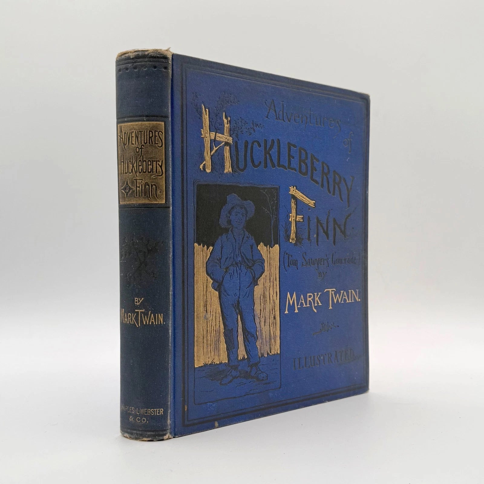 Adventures of Huckleberry Finn by Mark Twain 1885 first edition - original blue cloth binding with gilt vignette