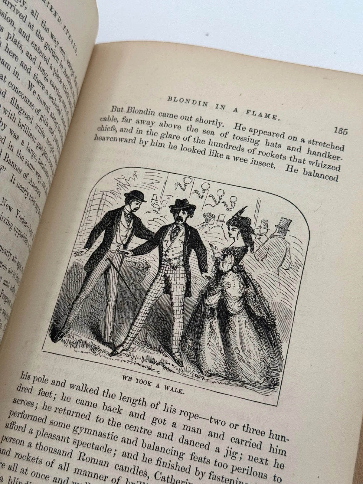 Open book with a vintage illustration of three people on a page.